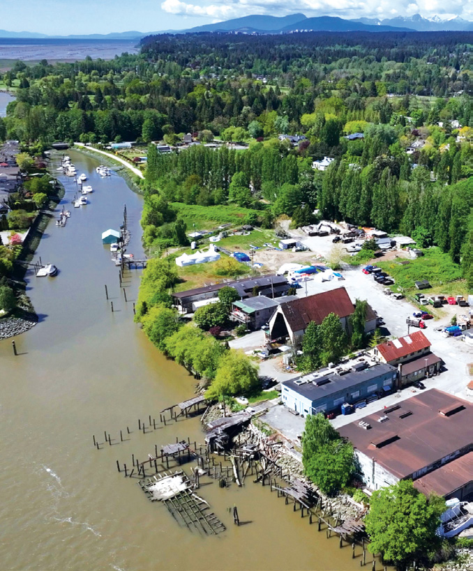 Aerial view showing the property and waterfront