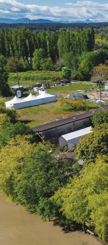 Aerial view of the property structures with mountain backdrop