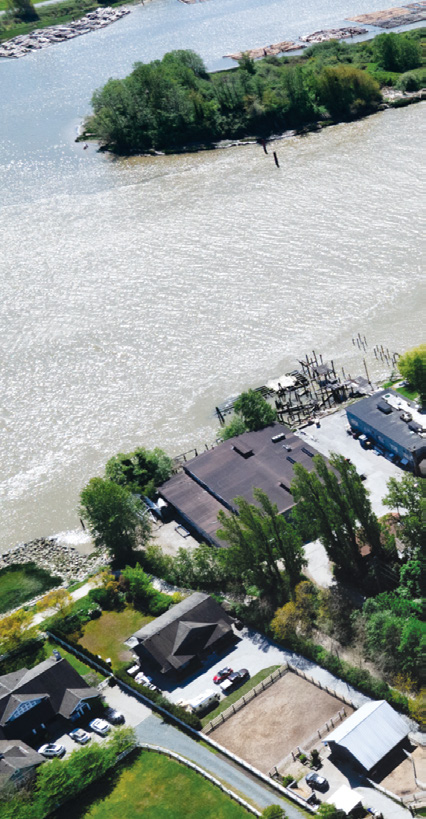 Aerial view of waterfront properties and dock facilities on the Fraser River
